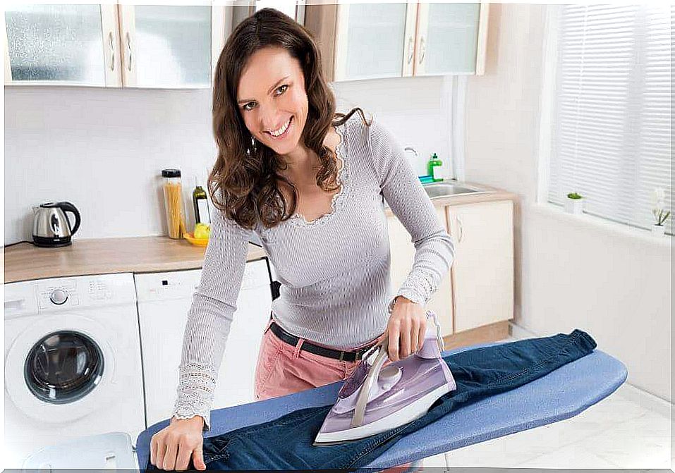 A woman ironing pants and aluminum foil under the fabric makes ironing easier