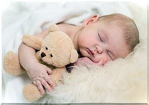 newborn baby with a teddy bear