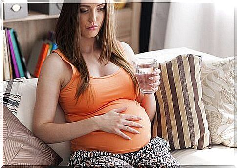 Pregnant with a glass of water