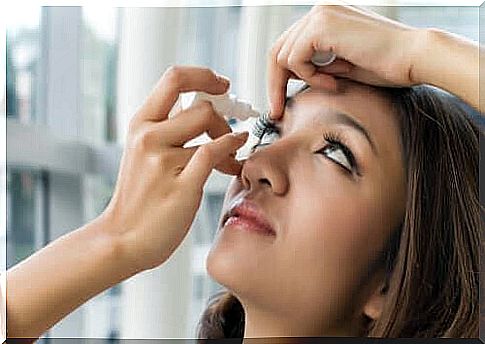 The woman drops her eye with the drug containing oxymetazoline