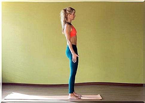 A fit woman is standing on an exercise mat