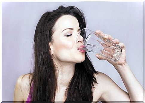 The woman drinks water to keep her kidneys healthy