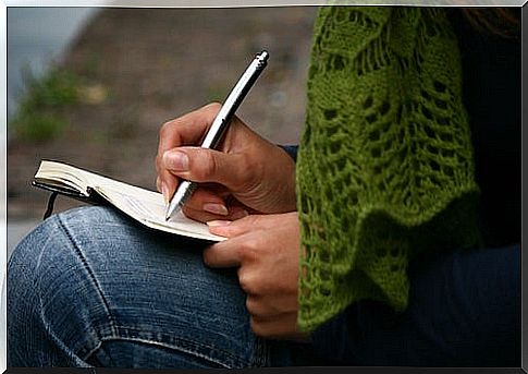 A person writing in a journal to become smarter