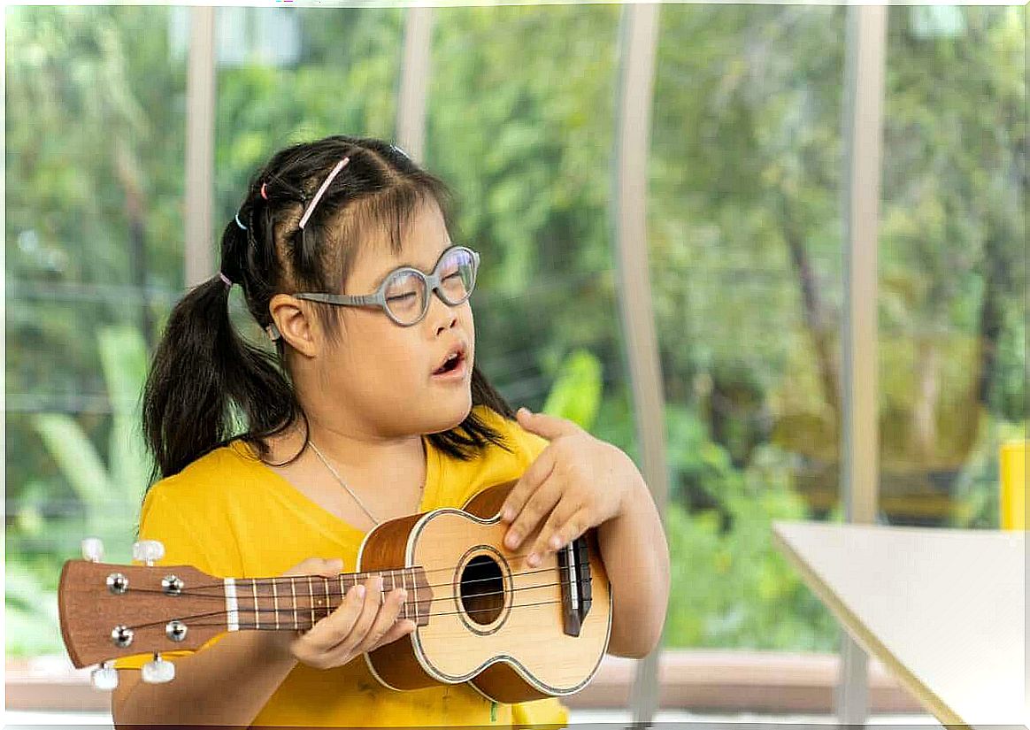 Girl with Down syndrome playing the ukulele