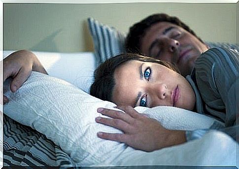 woman in bed suffers from insomnia