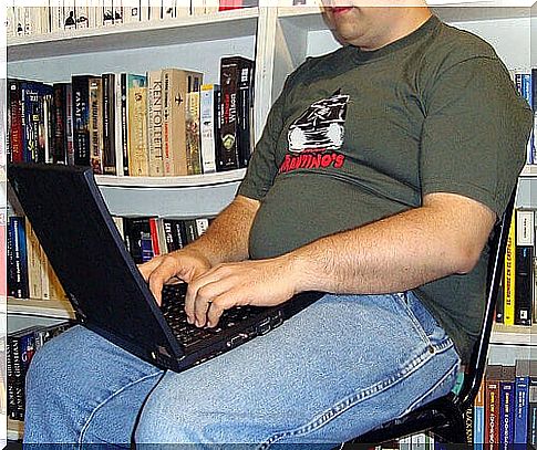 sitting in front of a computer and being overweight