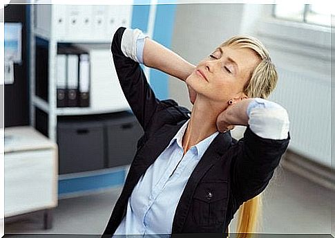 A woman in the office relaxes her neck