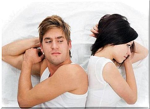 victim mentality, Couple in bed facing away from each other